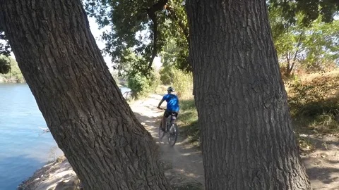 Biking Along the River Stock Footage 87157863