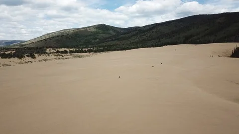 Biking and bouncing in the dunes Stock Footage 93604674