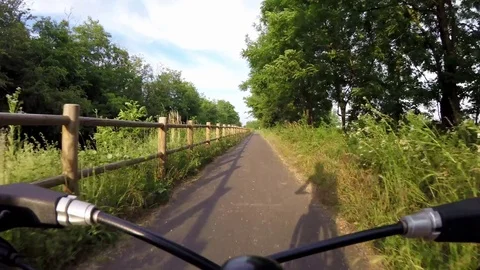 Biking on bike path in the park Stock Footage 76189114