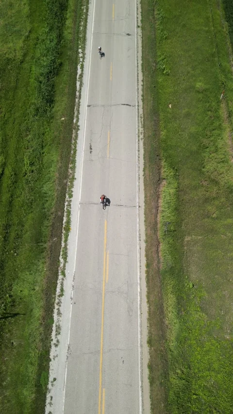 Biking down a long highway Stock Footage 304883702