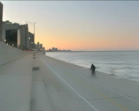 Biking at the lakefront PAL by in Stock Footage