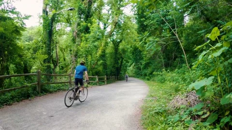 Biking in a park on the Delaware &amp; Lehigh Towpath Stock Footage 169128153
