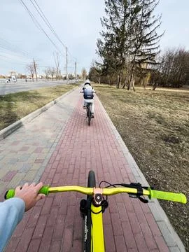 Biking on a Suburban Pathway in Early Spring During a Clear Day Photos