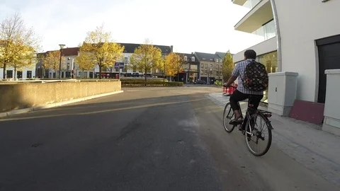Biking Through the city in evening sunlight Stock Footage 96750348
