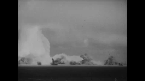 BIKINI ATOLL - 1946: Fleet blast - Water column erupts beside target ships Stock Footage 344498725