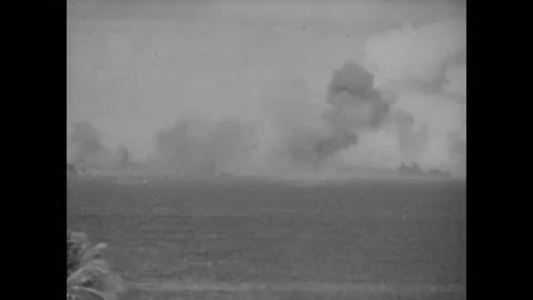 BIKINI ATOLL - 1946: Low viewpoint - Smoke columns mark the fleet horizon Stock Footage 344498687