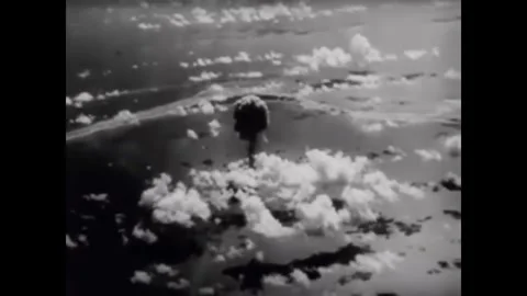 BIKINI ATOLL - 1946 - Mushroom clouds rise over Bikini Atoll in aerial view. A Stock Footage 341971128