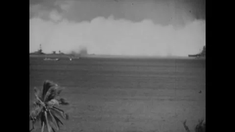 BIKINI ATOLL - 1946: Storm-dark shore - Pale surge spans the ship horizon Stock Footage 344498634