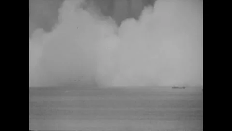 BIKINI ATOLL - 1946: White cloud mass - Towering spray dwarfs a lone vessel Stock Footage 344498602