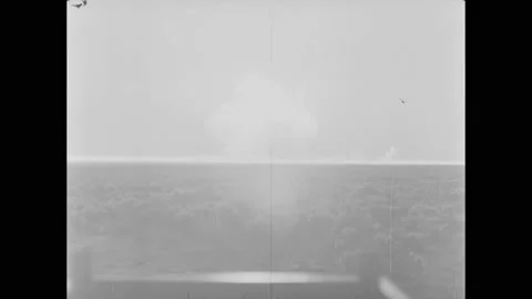 BIKINI ATOLL - 1955 - A mushroom cloud rises from an atomic bomb detonated off 스톡 동영상 304157283
