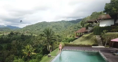Bikini Girl Walking on Infinity Pool in Bali Stock Footage 106236398