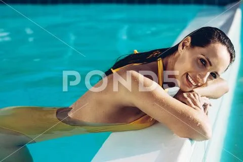 Bikini woman relaxing in a pool Stock Photos