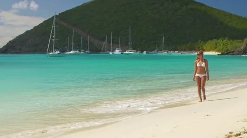 Bikini woman walking down a tropical beach Video stock 69781237