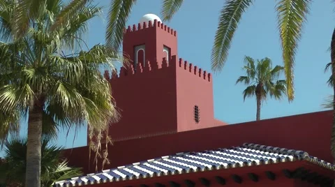 Bil Bil castle red building moving palms deep blue sky Andalucia Stock Footage 48469283