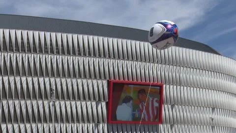BILBAO, SPAIN; MAY 11 2018: Inflatable rugby ball floats above modern stadium 스톡 동영상 335467441