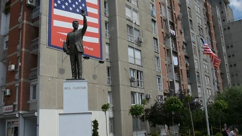 Bill Clinton status and waving flag of USA in Pristina, Kosovo Stock Footage