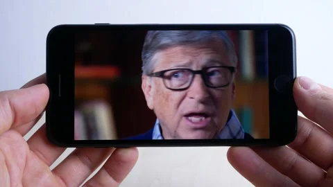 Bill gates interview, seen from smartphone, presents his new book, 2021 Stock Footage 161635925