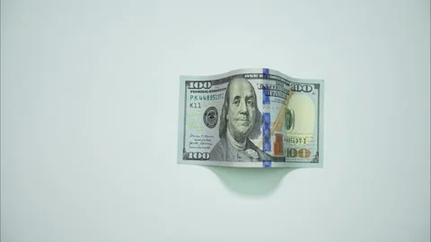 A bill of one hundred dollars crawls like a caterpillar from left to right Video stock 287950111