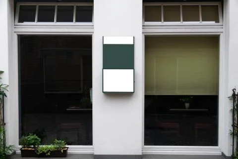 Billboard between windows of an small restaurant Stock Photos