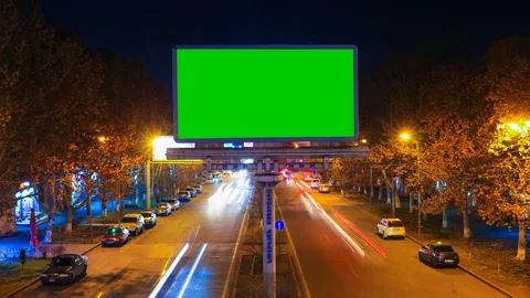 A billboard with green chroma key on a background of a city night landscape of Stock Footage 87334146