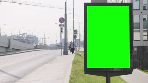 A billboard with a green screen located at ul. Nearby there is a road bridge on Stock Footage 142789876