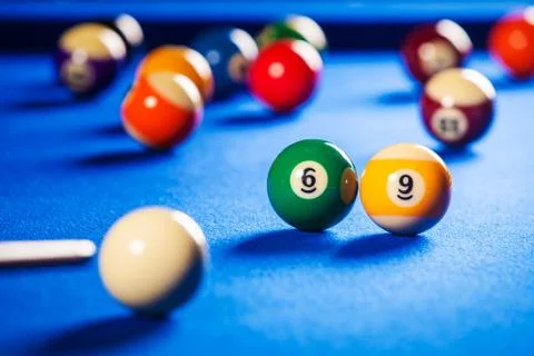 Billiard balls in a blue pool table Stock Photos