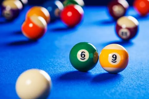 Billiard balls in a blue pool table Stock Photos