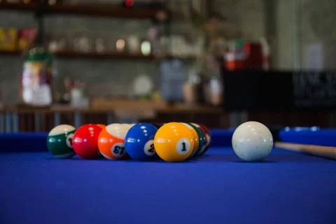 Billiard balls composition on blue pool table Stock Photos