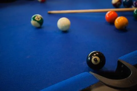Billiard balls composition on blue pool table Stock Photos