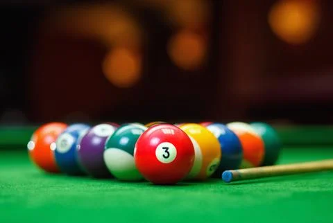 Billiard balls in a green pool table Stock Photos