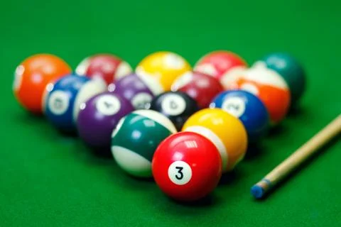 Billiard balls in a green pool table Stock Photos