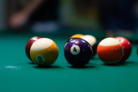 Billiard balls on green table in pool club copy space Stock Photos