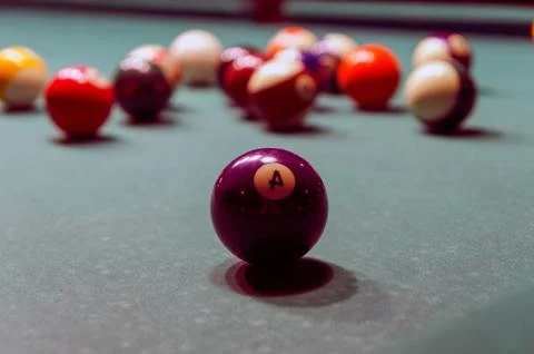 Billiard balls on pool table with focused foreground ball Stock Photos