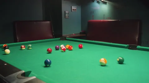 Billiard balls scattered across pool table after powerful break shot Stock Footage 302005881