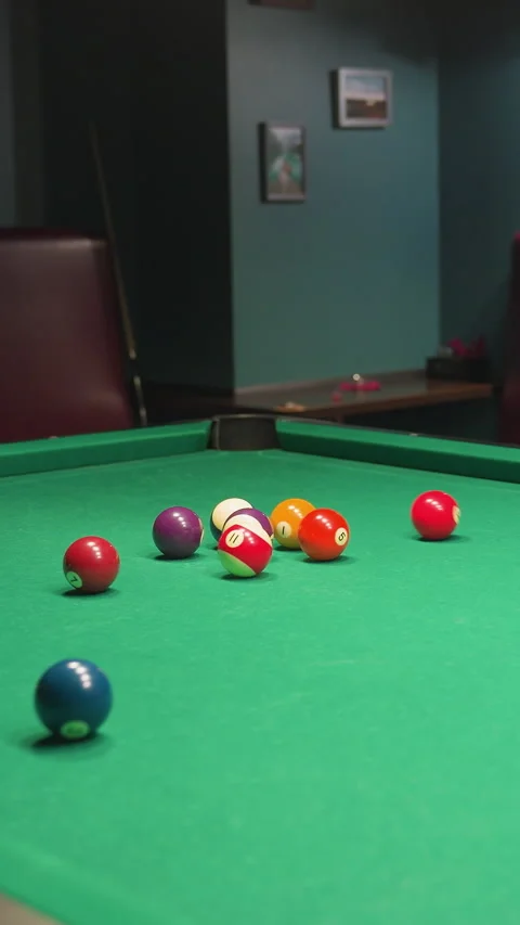 Billiard balls scattered across pool table after powerful break shot Stock Footage 319795361