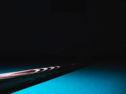Billiard cue on a table. Close-up. Black background Stock Photos