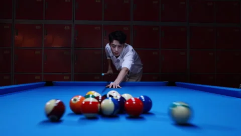 Billiard player with cue aiming at colorful balls opening spread on green pool Stock Footage 333311111