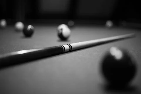 Billiard table in the billiard room with balls and cue Stock Photos