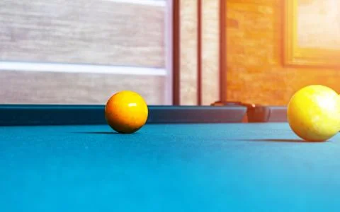Billiard table close up. Playing billiard. Billiards balls and cue on green.. Stock Photos