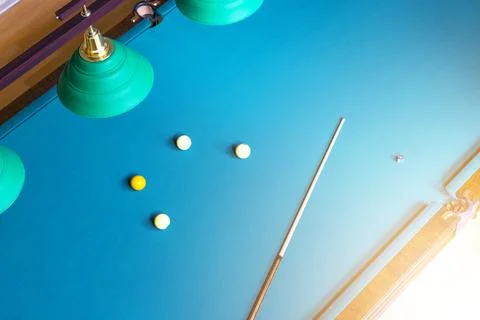 Billiard table close up. Playing billiard. Billiards balls and cue on green.. Stock-Fotos