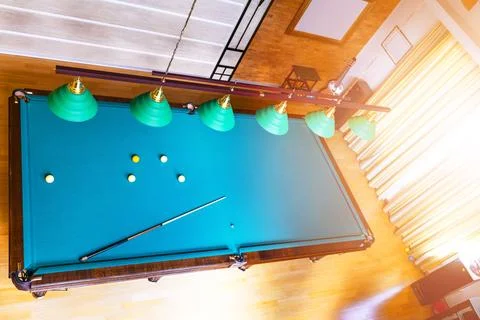 Billiard table close up. Playing billiard. Billiards balls and cue on green.. Stock Photos