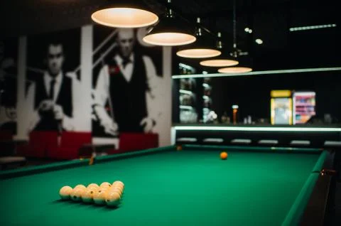 Billiard table with green surface and balls in the billiard club. Stock Photos