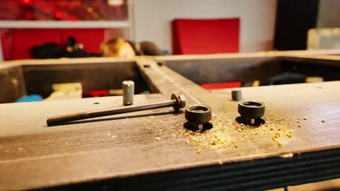 Billiard Table Renovation Hardware and Wood Dust With Craftsman Working Behind Stock-Footage 344095712