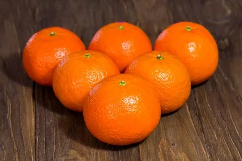 Billiard triangle composition of the tangerines on the center of the wooden Stock Photos