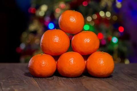 Billiard triangle composition of the tangerines on the center of the wooden Stock Photos