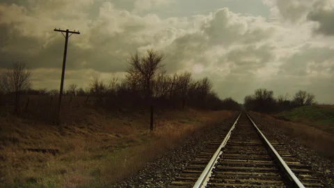 Billowing clouds float above Railroad Tracks on a late winter day. Stock Footage 231262862