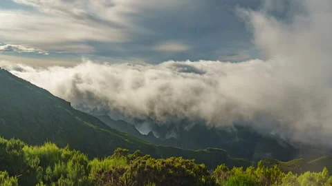 Billowing clouds rolling along a green mountain slope in Madeira near Pico Ruivo Видео 347200203
