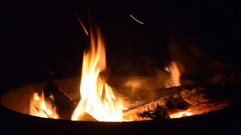Billowing flames in a campfire pit at night closeup Stock Footage 105556690
