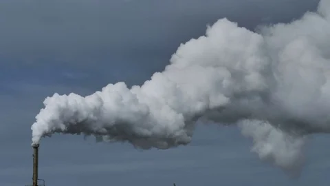 Billowing steam from smoke stack across sky 4k, slow motion wide Stock Footage 78984581