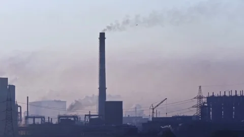 Billowing steam from smoke stack filling sky. Smoking chimneys of a steel pow 動画素材 112775203